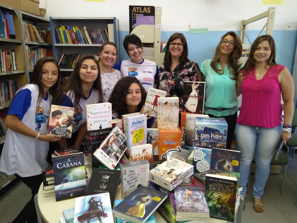 A gerente regional da Seja Digital Daniela Honório com alunos e representantes da escola Jerônimo Barbosa Sandoval durante a entrega dos 95 livros 